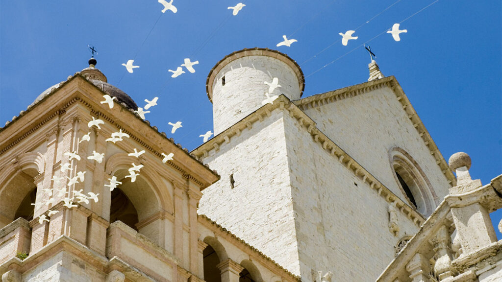 Doves flying over church
